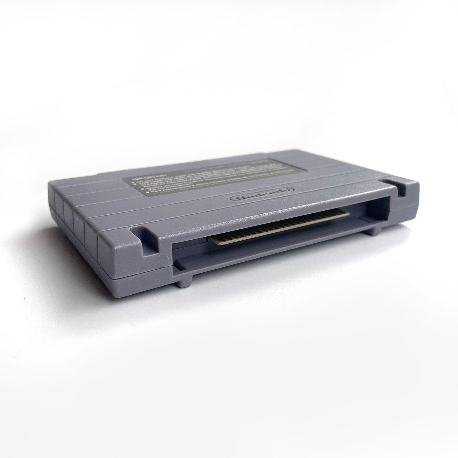 Side view of Teenage Mutant Ninja Turtles IV: Turtles in Time SNES cartridge shell.

